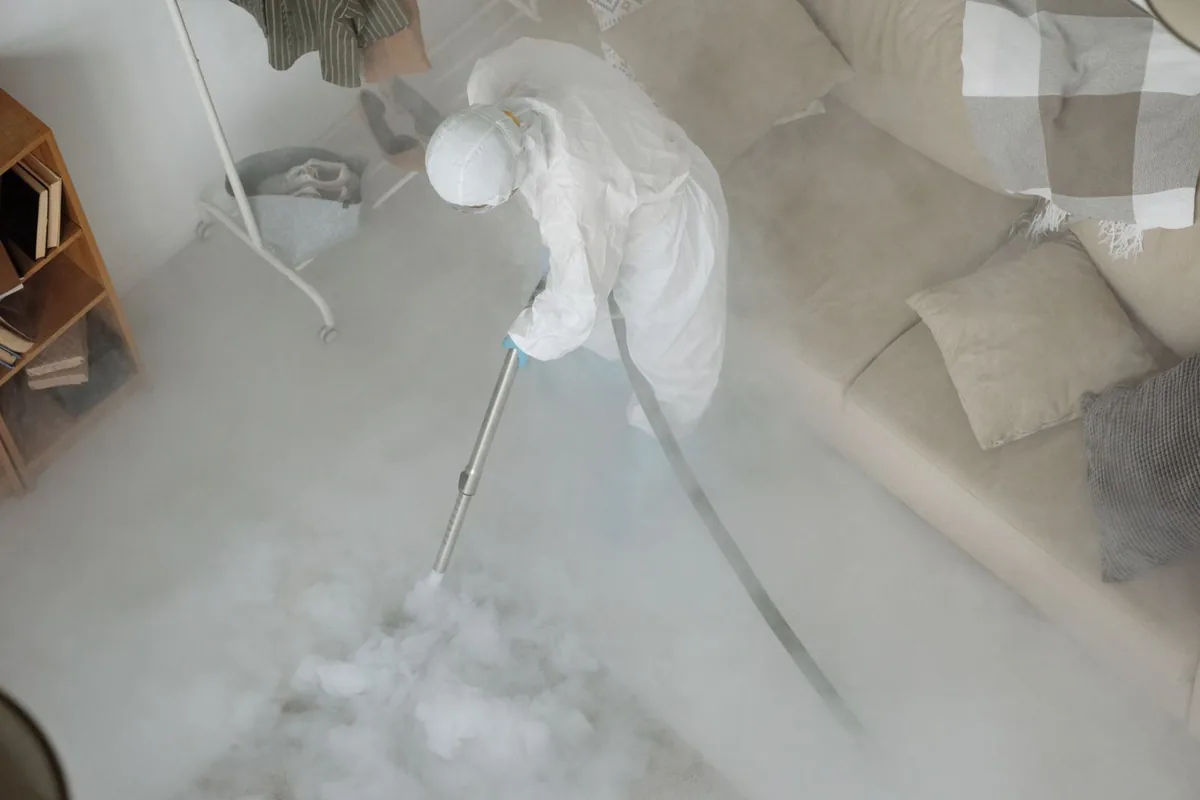 Biohazard cleanup technician in protective equipment, Paola, KS